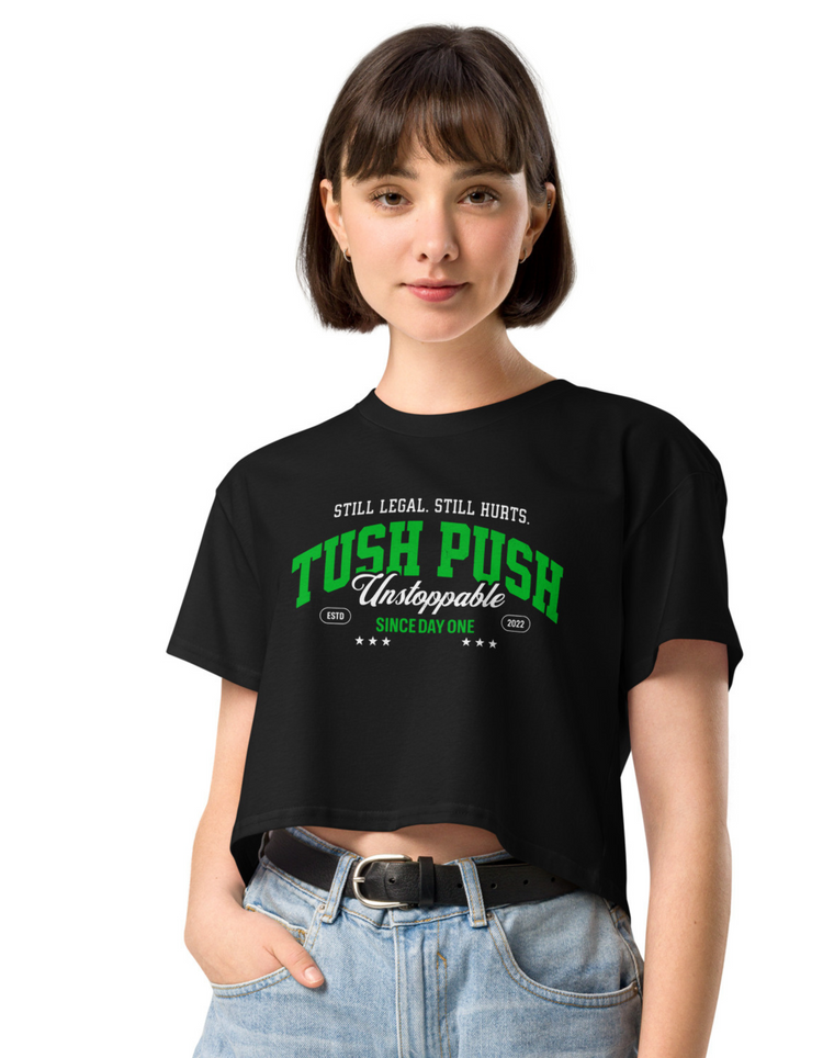 Woman lounging in a bright pink shirt with Tush Push Logo printed