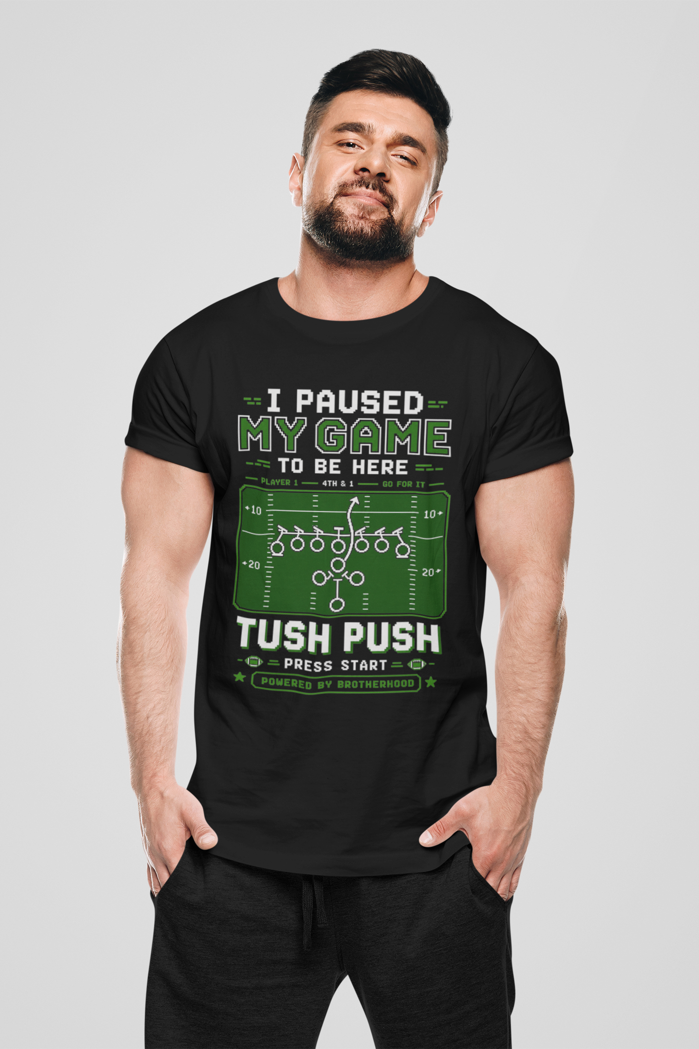 Man wearing a black t-shirt with humorous gaming text design on a plain background